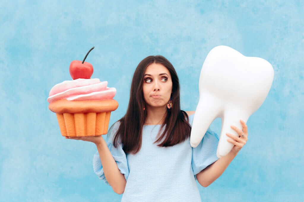 Girl having dental problems after eating too much sugar